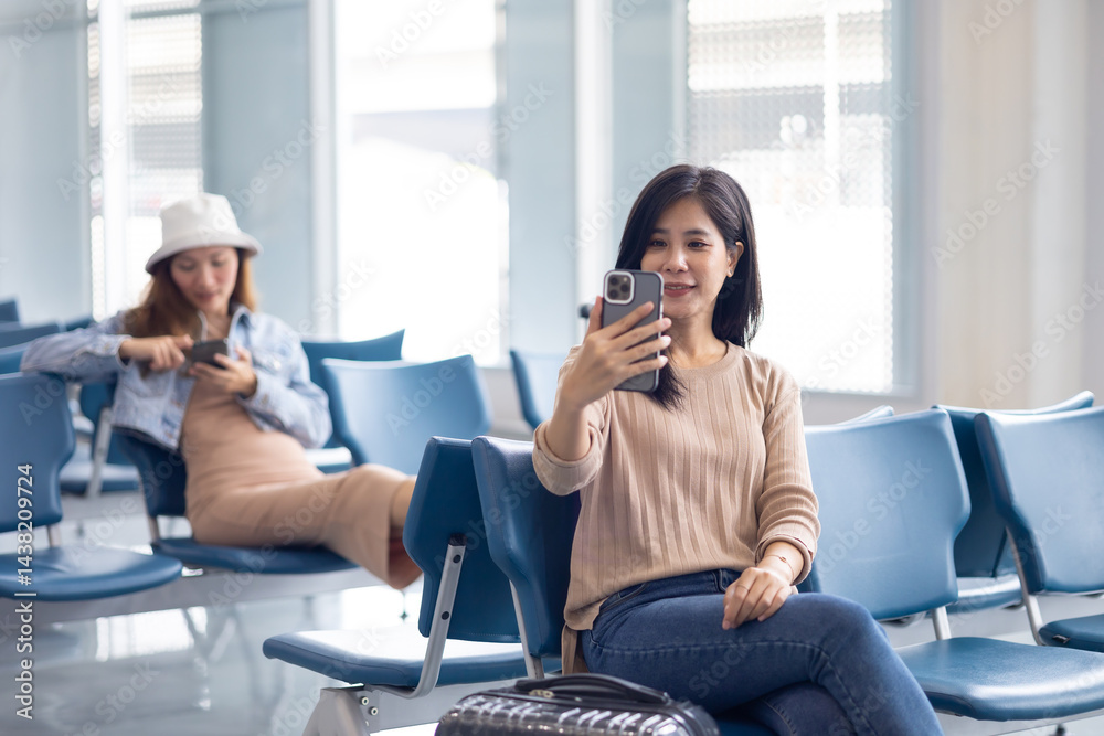 Happy Asian Woman waiting for flight at airport lounge. Happy asian woman passenger traveler waiting for departure with suitcase at modern airport terminal