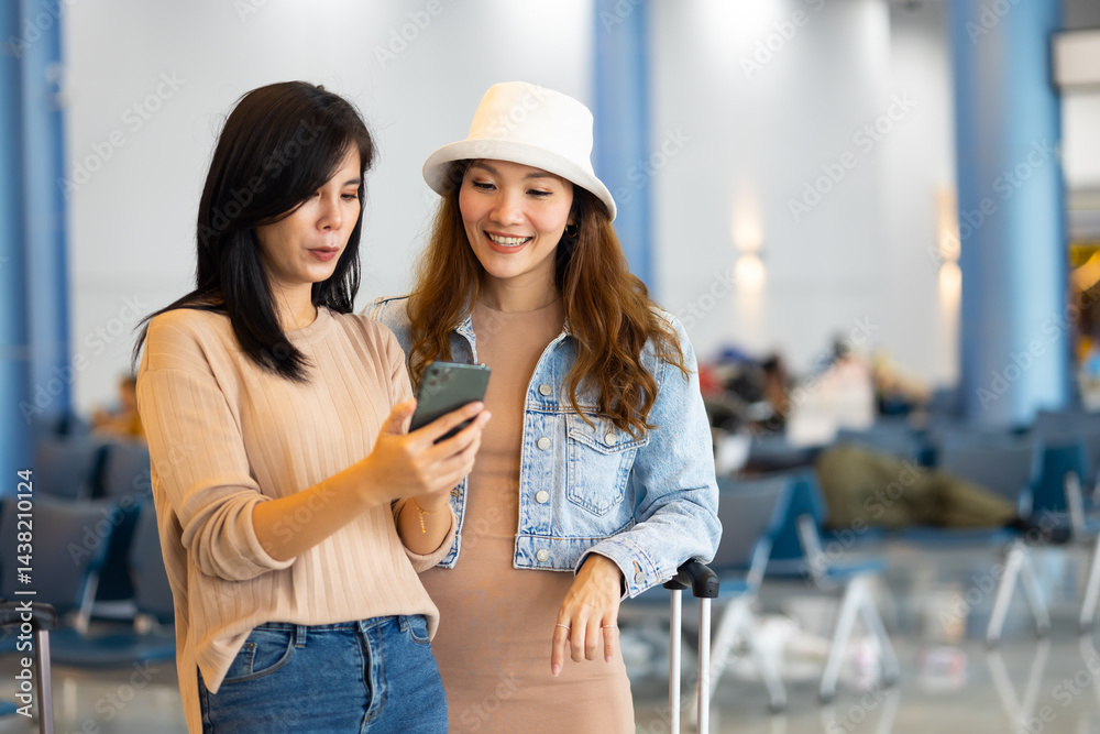 Internet Online Check flight schedule on smartphone. arrival and departure board. Two Asian woman use smartphone cheking flight for travel in long weekend