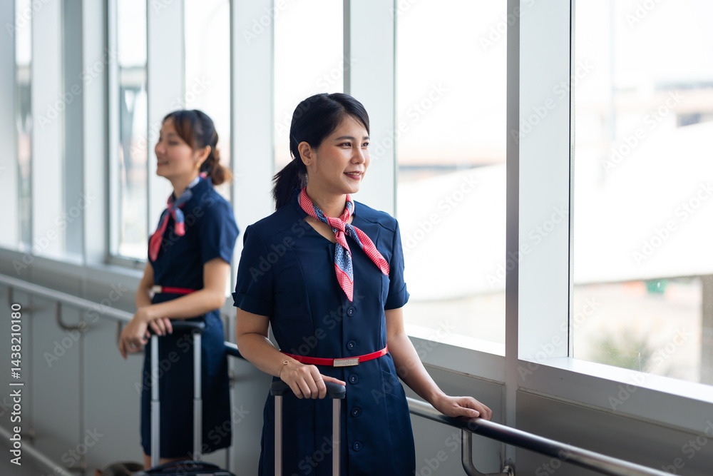 Portrait female Cabin crew or air hostess in airport. Cabin crew, air hostess working in airplane. Service mind. Asian stewardess with suitcase at modern airport terminal. flight attendant