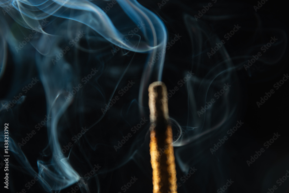 Fototapeta premium Abstract swirling incense smoke in soft blue tones.