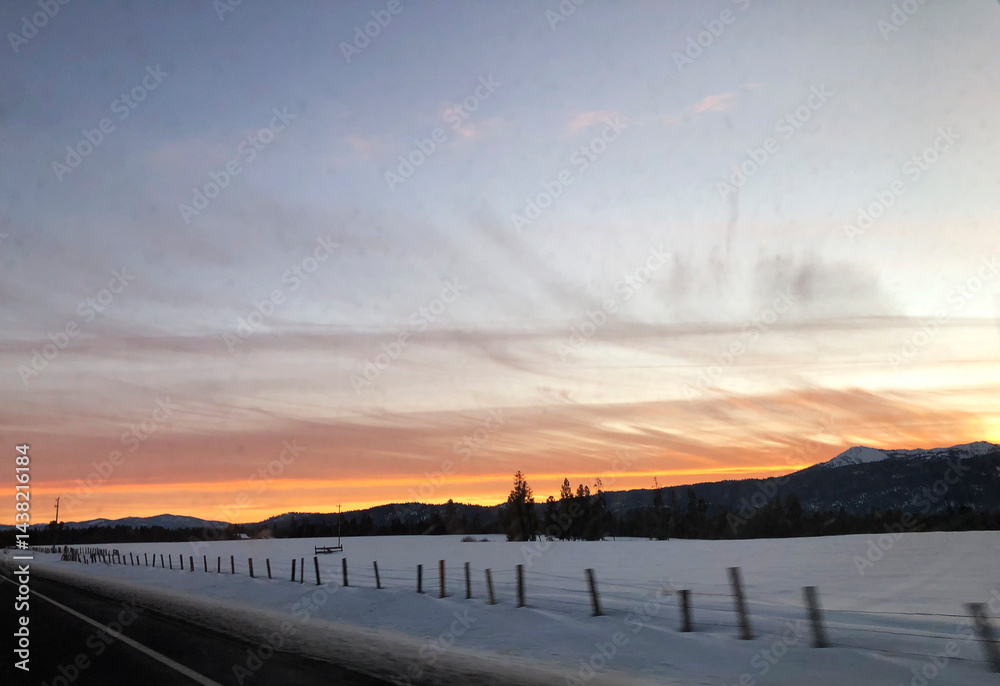 Obraz premium Sunset on the road from Brundage Mountain ski resort. View from car.