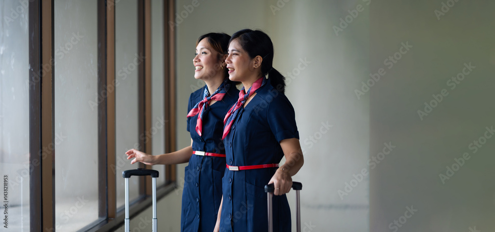 Portrait two Cabin crew or air hostess in airport. Cabin crew, air hostess working in airplane. Service mind. Asian stewardess with suitcase at modern airport terminal. flight attendant