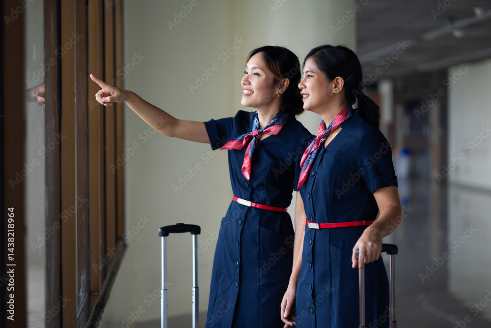 Portrait two Cabin crew or air hostess in airport. Cabin crew, air hostess working in airplane. Service mind. Asian stewardess with suitcase at modern airport terminal. flight attendant