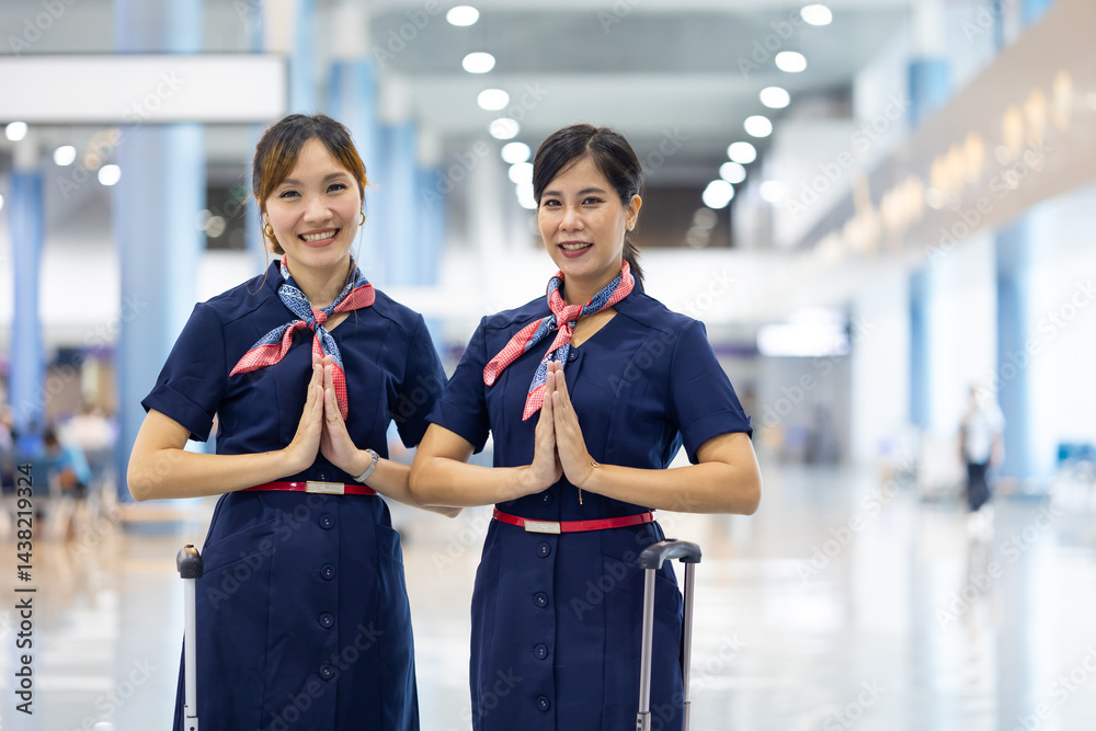 Portrait two woman friends sawasdee thai hello in airport. Cabin crew, air hostess working in airplane. Service mind. Asian stewardess with suitcase at modern airport terminal. flight attendant