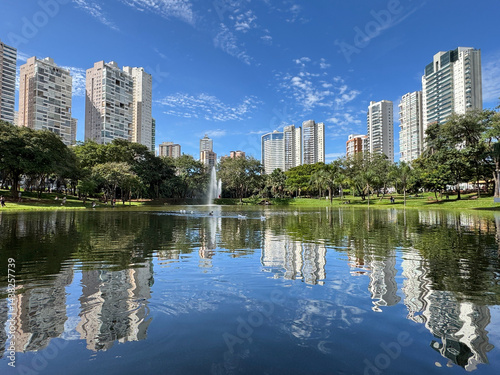 Wonderful view of Flamboyant Park with lake, tropical nature and modern buildings in Goiania, Goias, Brazil 