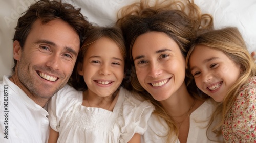 Happy family lying on bed