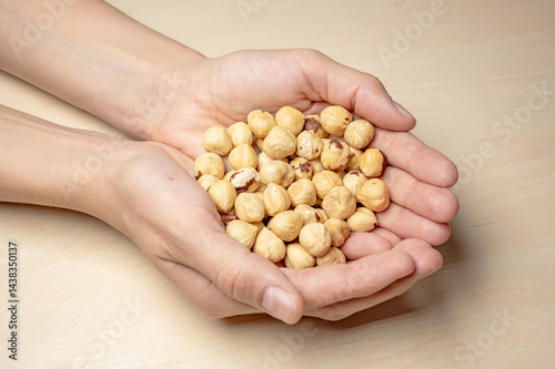 Hazelnuts in the hands of a girl. Isolate of nuts