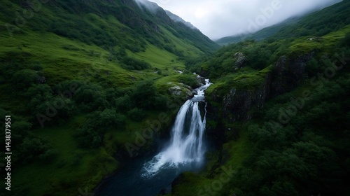 Ethereal cascade: Water plummeting down a verdant cliffside beneath misty peaks