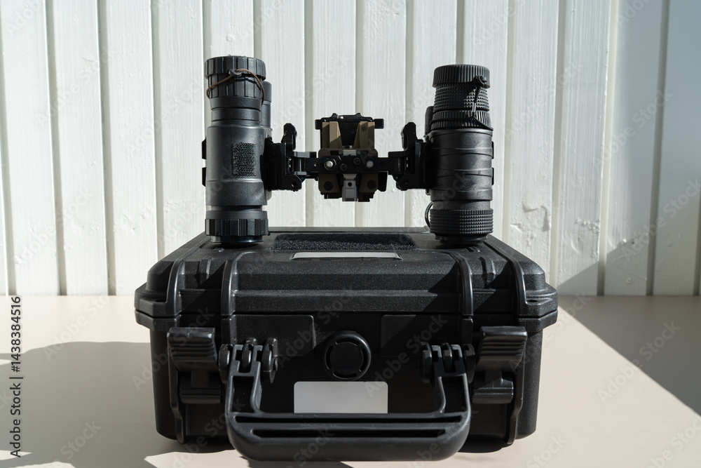 Φωτογραφία A set of professional military gear: modern binocular night vision goggles and a shockproof case for storage and transport in any conditions