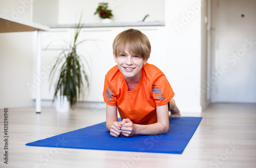 Smiling Boy Training at Home, Indoor Fitness Concept