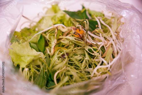 Fresh mixed salad greens inside a clear plastic bag