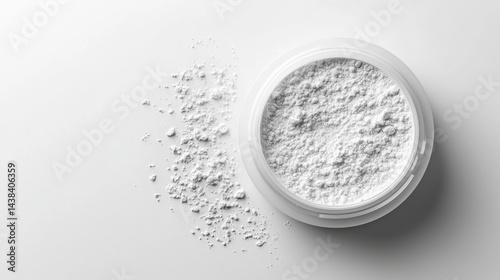 Fine white powder in round container on clean surface