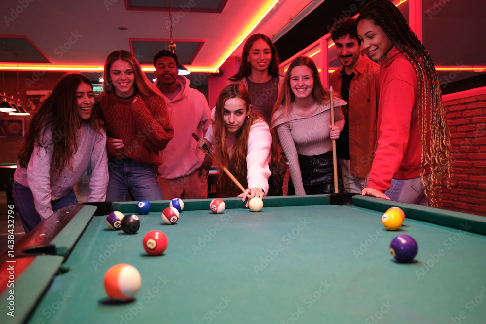 Group of friends playing pool in a billiard room, enjoying leisure time together