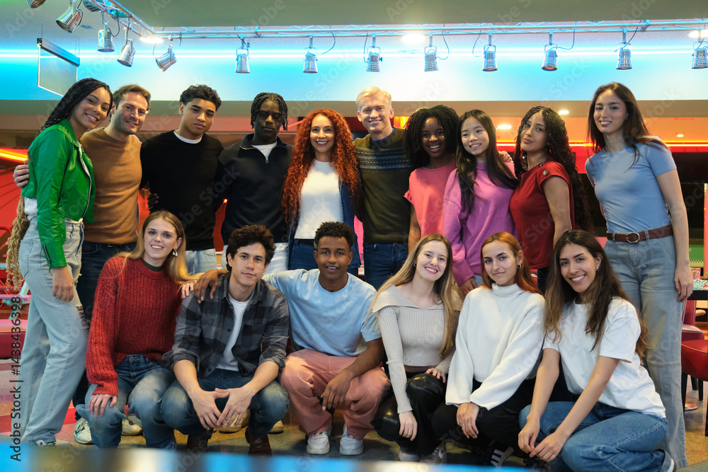 Multi ethnic group of students smiling together in a bowling alley, celebrating their friendship and diversity
