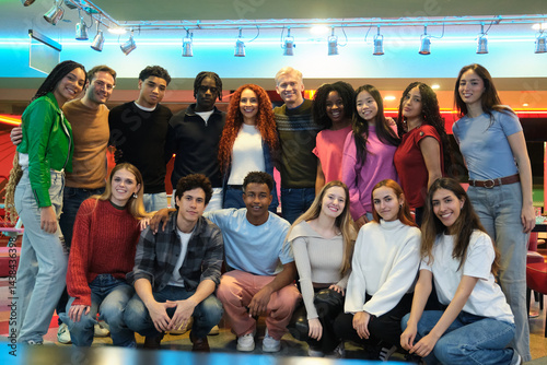 Obraz na płótnie Multi ethnic group of students smiling together in a bowling alley, celebrating their friendship and diversity w salonie