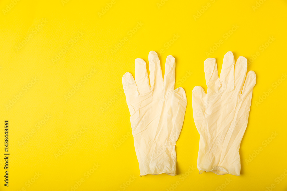 Obraz premium Medical nitrile gloves,blue cap, disposable medical mask on textured background. Medic protective clothing. Surgical latex gloves. Rubber gloves manufacturing.Medicine concept. Top view. Copy text
