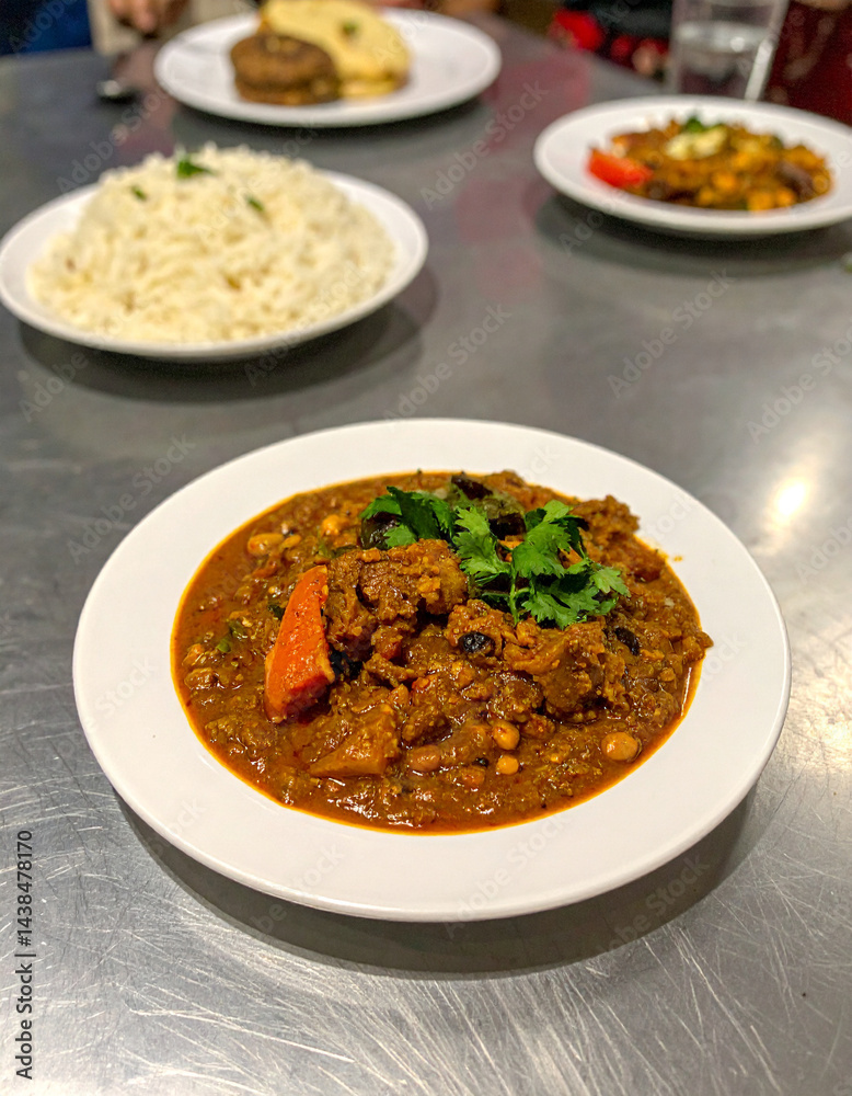 A steaming plate of flavorful haleem, a slow-cooked stew with meat, lentils, and wheat, a popular and hearty dish in Pakistan. A steaming plate of flavorful haleem, a slow-cooked stew with meat, lentils, and wheat, a popular and hearty dish in Pakistan.