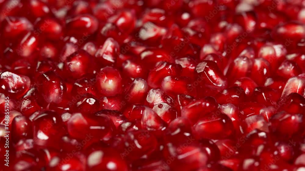 Juicy pomegranate seeds rotate as background showcase. Ruby pomegranate grains or garnet for satisfying, advertising and promotions. Juicy grenadine fruit natural antioxidant