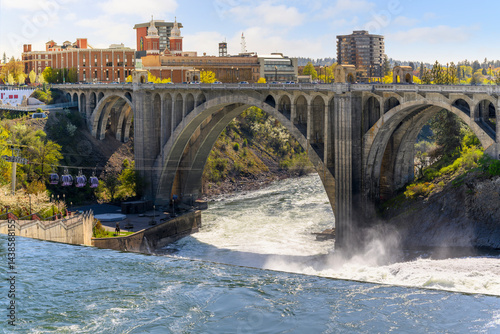 Fototapeta Naklejka Na Ścianę i Meble -  The Monroe Street Bridge as it spans the Spokane River at the Lower Falls region near Huntington Park and Riverfront Park in Spokane, Washington at early Spring.