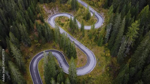 aerial view of a twisted road in a forest