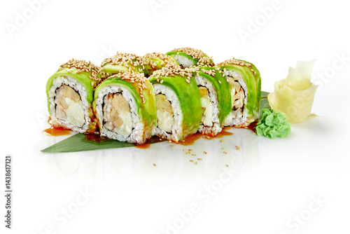 Green dragon sushi rolls with avocado, sesame seeds, and unagi sauce on white background