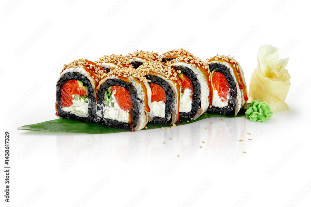 Black sushi rolls with salmon, cream cheese and sesame seeds on green leaf