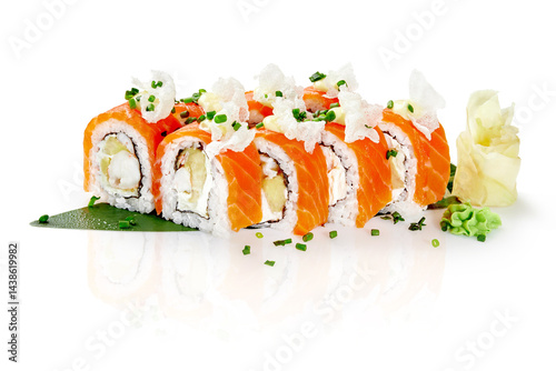 Philadelphia uramaki sushi rolls with salmon, cream cheese and mango presenting on banana leaf