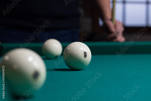 Russian billiards balls on green table cloth and player
