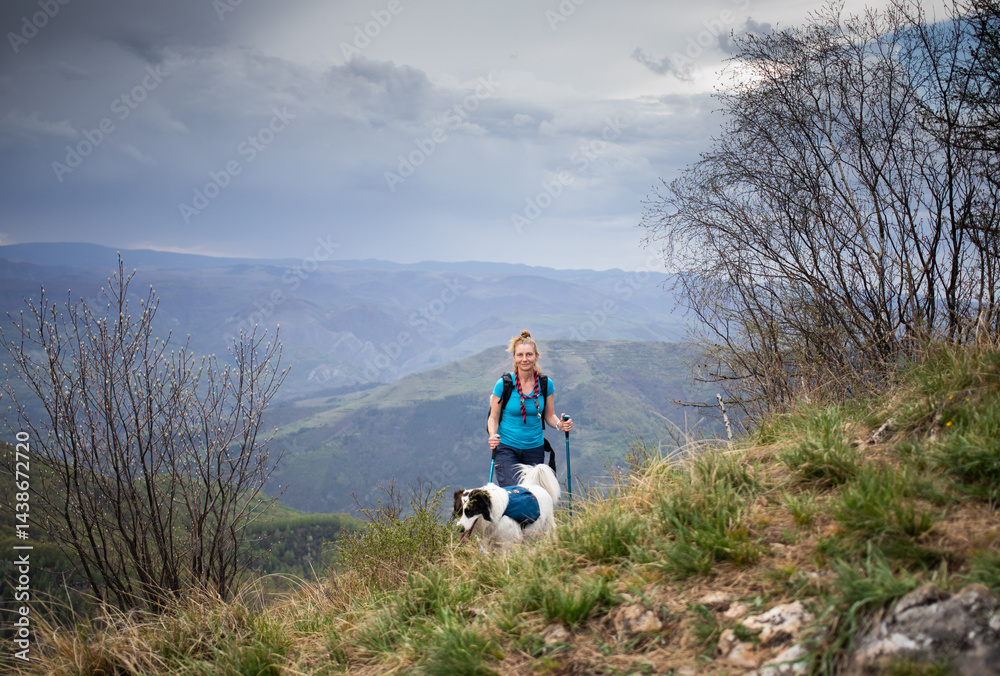 fit woman hiking with her dog