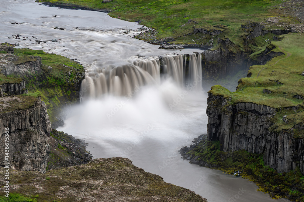 Hafragilsfoss waterfall. Long exposure smooths the glacier river's fierce descent. Stark cliffs frame Iceland's power. Hafragilsfoss waterfall. Long exposure smooths the glacier river's fierce descent. Stark cliffs frame Iceland's power.