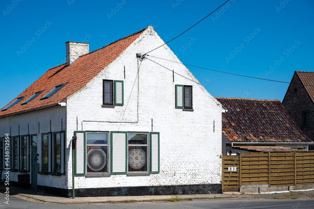 White traditional house at a corner street in Poperinge, West Flanders, Belgium White traditional house at a corner street in Poperinge, West Flanders, Belgium