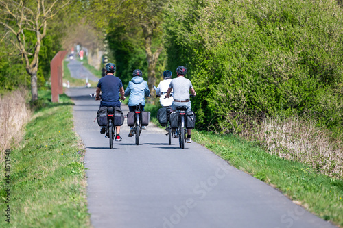 E bike cyclists driving the Vredes fietsroute cycling trail in Langemark - Poelkapellen, Ieper,  West Flanders, Belgium