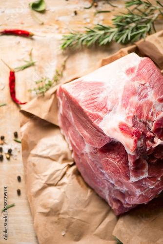 Raw Pork meat fillet. Fresh Pork meat, piece of meat close up. Prime filet meat texture. Chilled pork Boston butt, collar, shoulder. Steak. Raw pork neck, Spices. On wooden table background, vertical