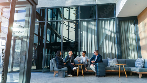 Photos Business travel, meeting and people on couch in airport, terminal lounge and lobby with professional employees