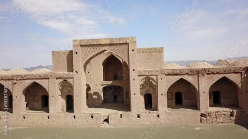 aramgah asrar in khorasan iran. Drone aerial view of ancient caravanserai ruins in the desert with standing brick arches and surrounding open land, showcasing Persian architectural heritage