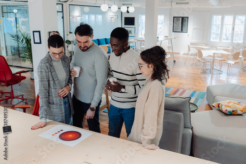 Marketing professionals analyzing target market data in modern office