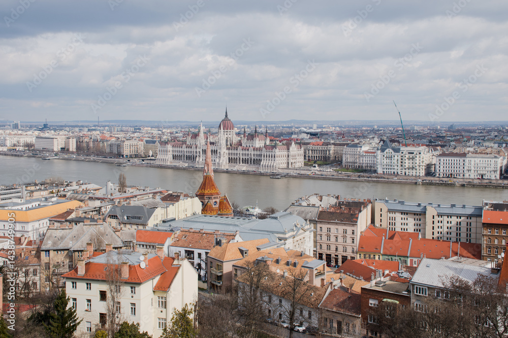 Fototapeta premium A panoramic view of the city of Budapest in Hungary over the river Danube as seen from Buda Castle; with the parliament building.