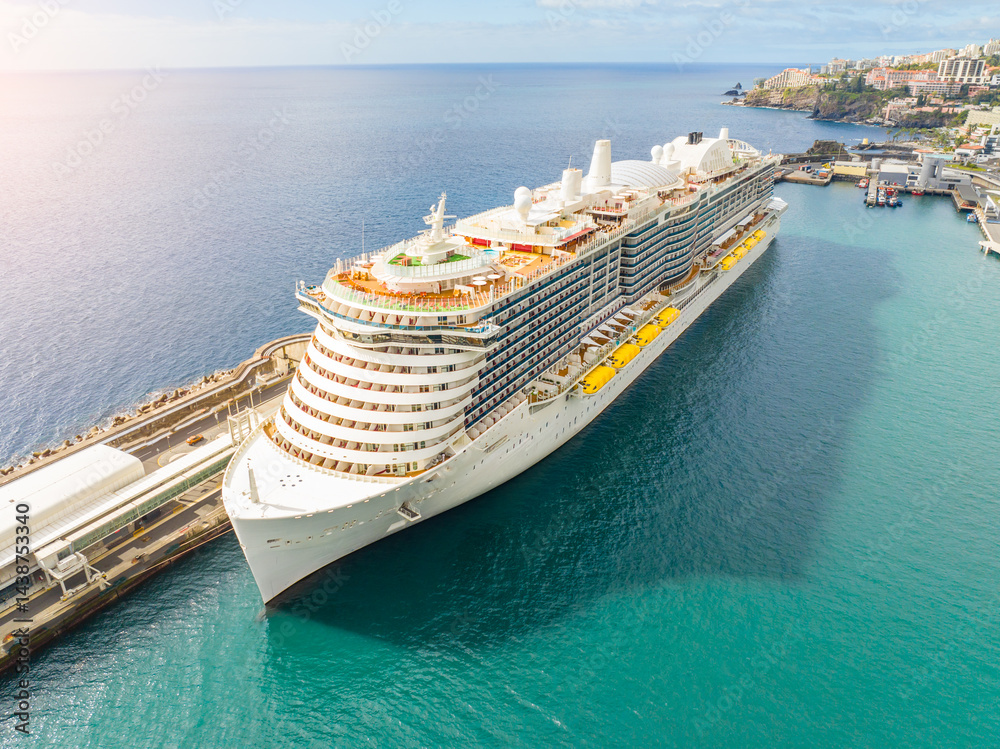 Luxurious cruise ship sails through azure waters, offering an unforgettable vacation experience and stunning coastal views