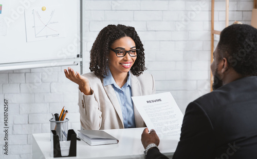 Friendly personnel manager interviewing black candidate during job interview at modern office, panorama
