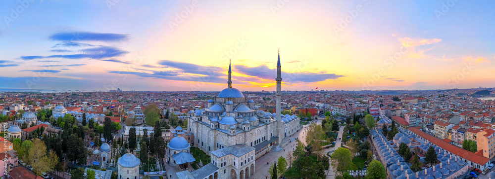 Naklejka premium Stunning Aerial View of Istanbul's Fatih Mosque Sunset. A breathtaking aerial panorama of Istanbul, Turkey, centered on the Fatih Mosque at sunrise. Sultanahmet Mosque, Ayasofya, Suleymaniye. Kandil