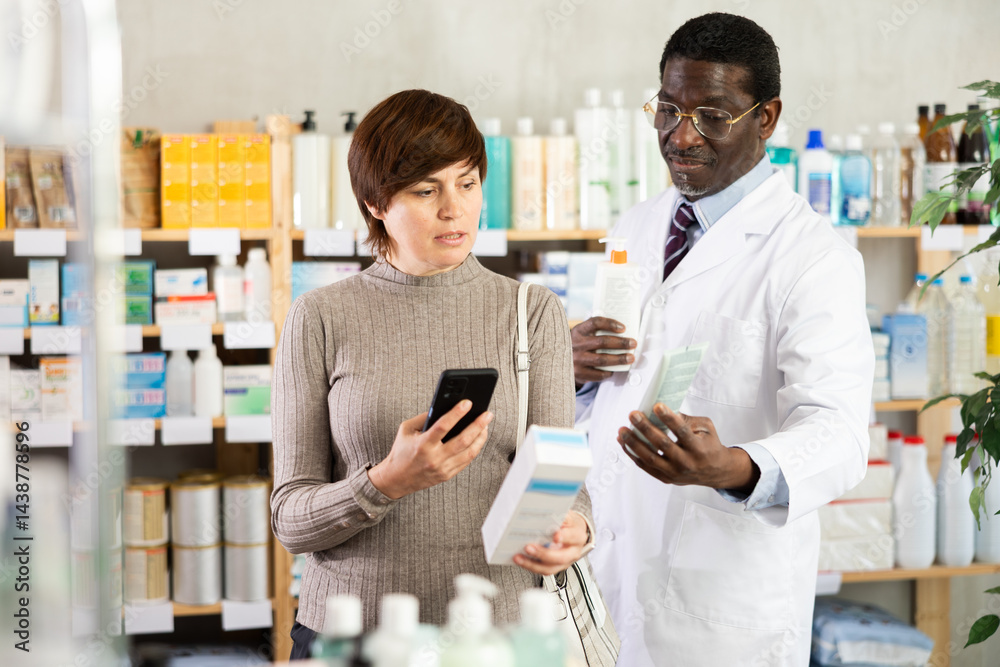 Obraz premium Woman in pharmacy scans QR code atopic cream product, checks certificate on manufacturers website. Client learns information about product, reviews and recommendations for use