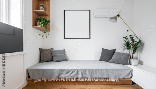 Minimalist bedroom interior with gray bedding, wooden platform bed, plants, and a blank frame on a white wall.