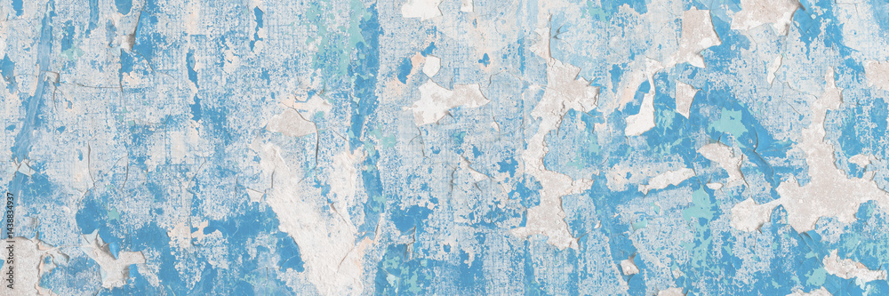 Blue peeling paint on the wall. Old concrete wall with cracked flaking paint. Weathered rough painted surface with patterns of cracks and peeling. High resolution texture for background and design.