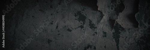 Dark wide panoramic background. Peeling paint on a concrete wall. Dark grunge texture of old cracked flaking paint. Weathered rough painted surface. Patterns of cracks. Darkness background for design.