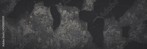 Obraz na płótnie Dark wide panoramic background. Peeling paint on a concrete wall. Faded dark texture of old cracked flaking paint. Weathered rough painted surface with patterns of cracks. Shaded background for design w salonie