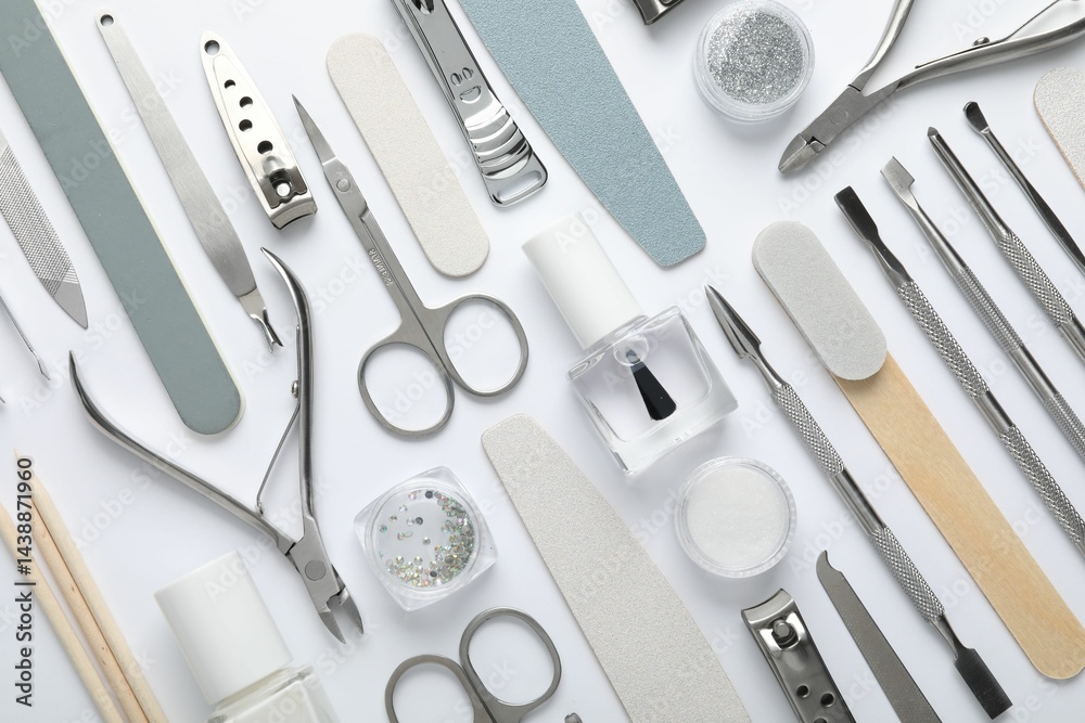 Set of different manicure tools on white background, flat lay Set of different manicure tools on white background, flat lay