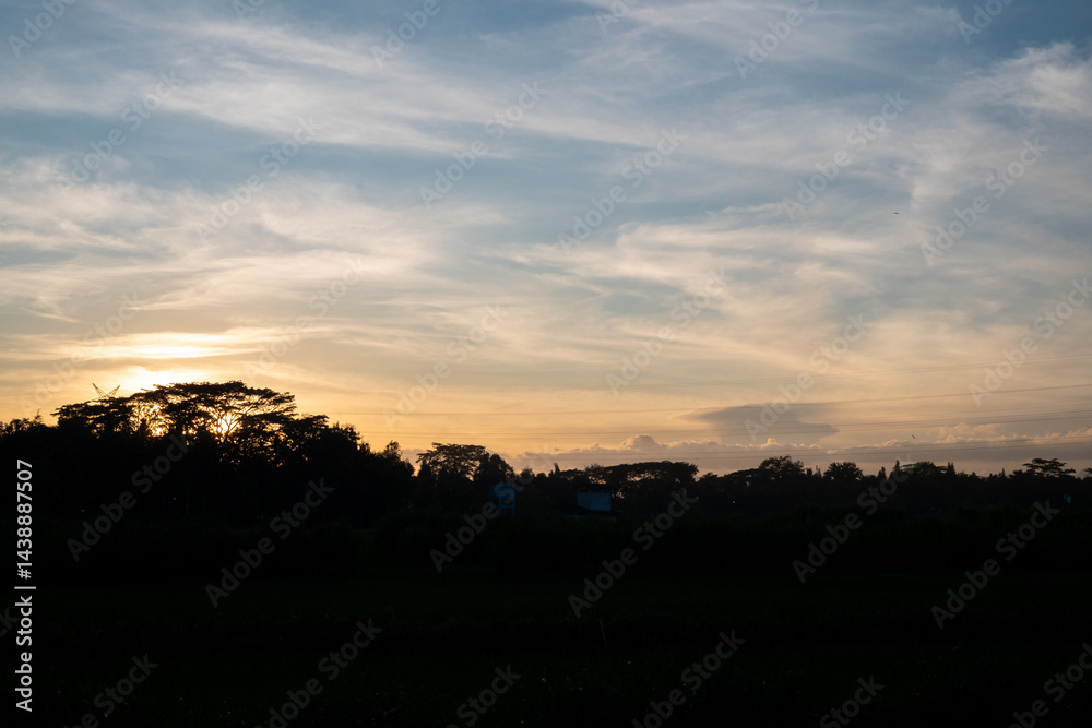 Blue background of sky and clouds in the evening with a panoramic view of the sunset and shadows from the trees Blue background of sky and clouds in the evening with a panoramic view of the sunset and shadows from the trees