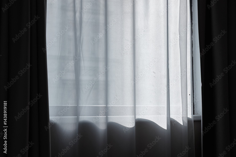Window curtain in a plain hotel room