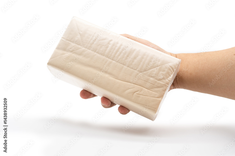Hand holding Brown tissue paper pack isolated on white background.