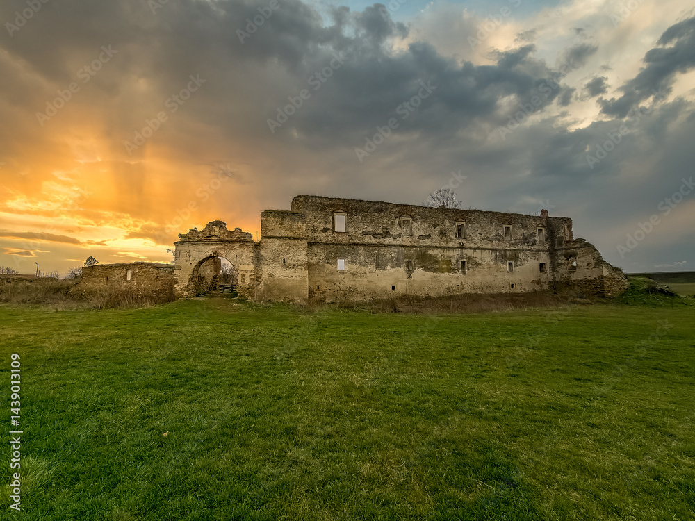 View of Alvinc Martinuzzi Castle ruin in Vintu de Jos, Transylvania Romania with colorful sunset